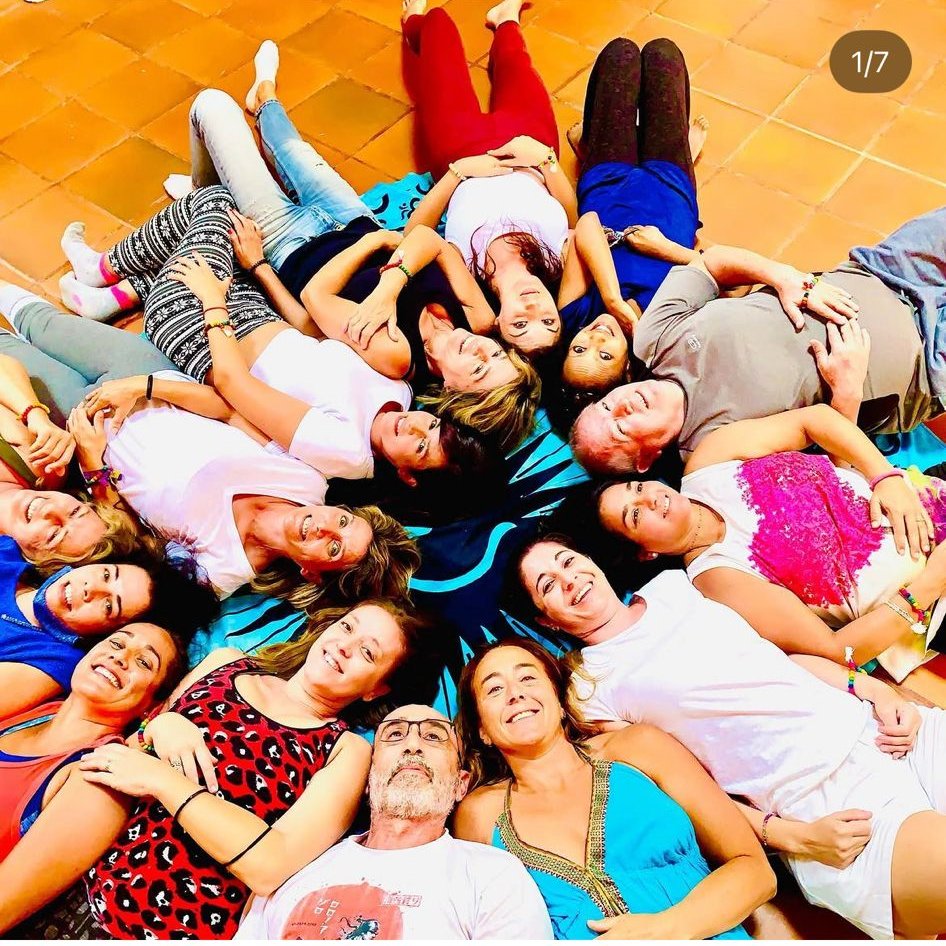 El grupo del retiro tumbado en círculo sonriendo